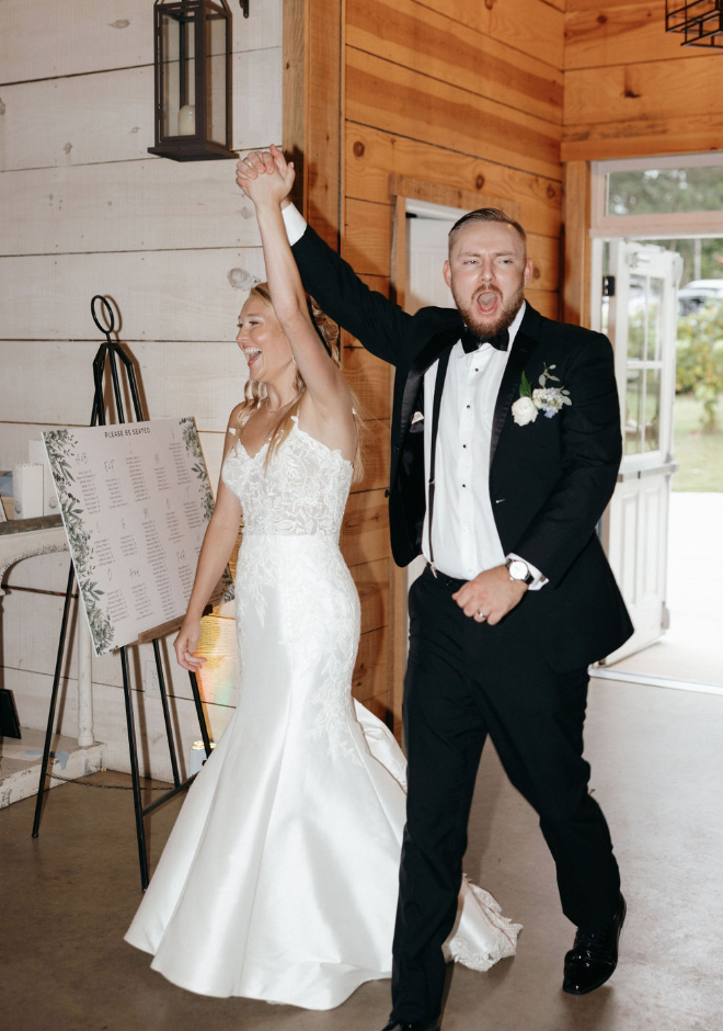 Bride and groom walking into wedding reception